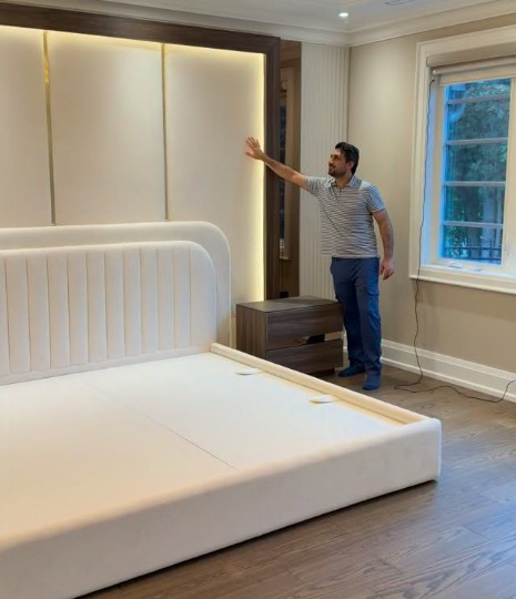 Custom white bed and tall illuminated wall panels